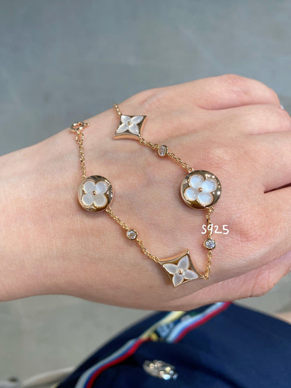 ˇGilded EraˇSTAR AND SUN 4 MOTIF WHITE MOP PINK GOLD BRACELET