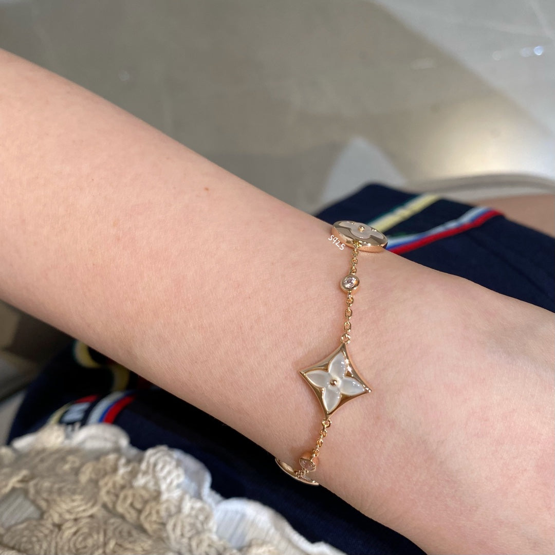 ˇGilded EraˇSTAR AND SUN 4 MOTIF WHITE MOP PINK GOLD BRACELET
